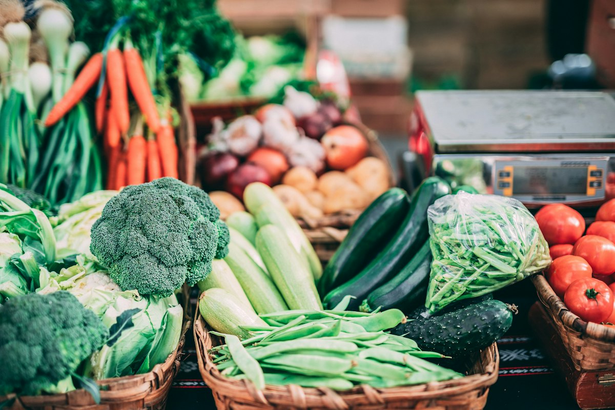 A colourful display of fresh vegetables and fruit at a market