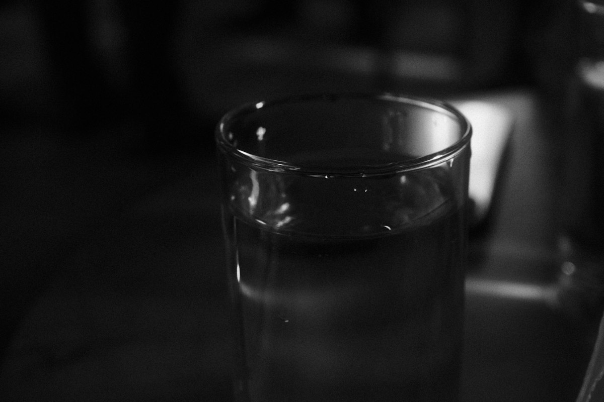 A clear glass of water in soft side lighting
