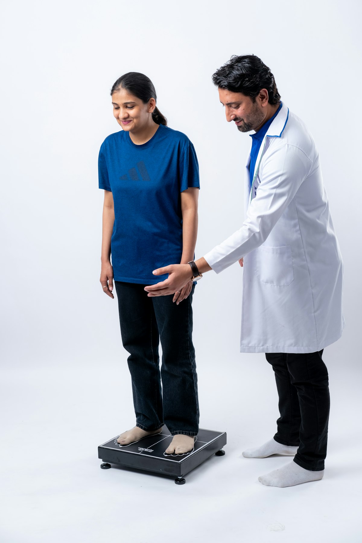 A clinician guiding a standing patient during an assessment